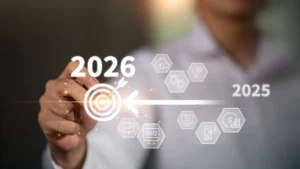 Businessman pointing to digital target icon with transition from 2025 to 2026,